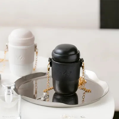 Stylish ceramic water bottle ceramic body gold-toned chain strap trendy design versatile style perfect for everyday
